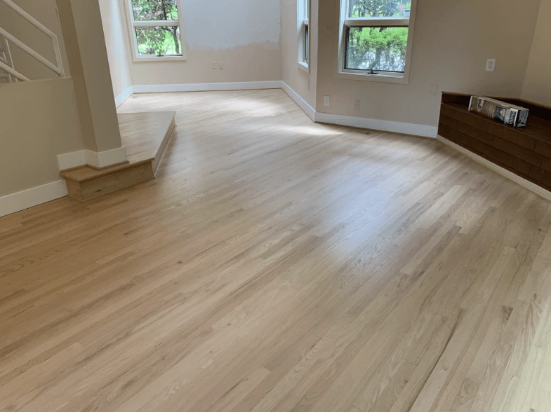 Light oak hardwood flooring running through an open Broken Arrow living room