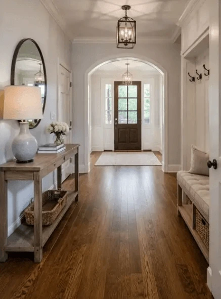 Hardwood entryway floor leading down a hallway to the front door