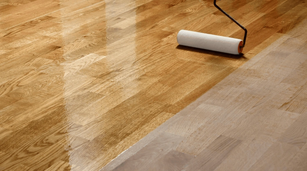 Fresh protective coat being rolled over a screened hardwood floor