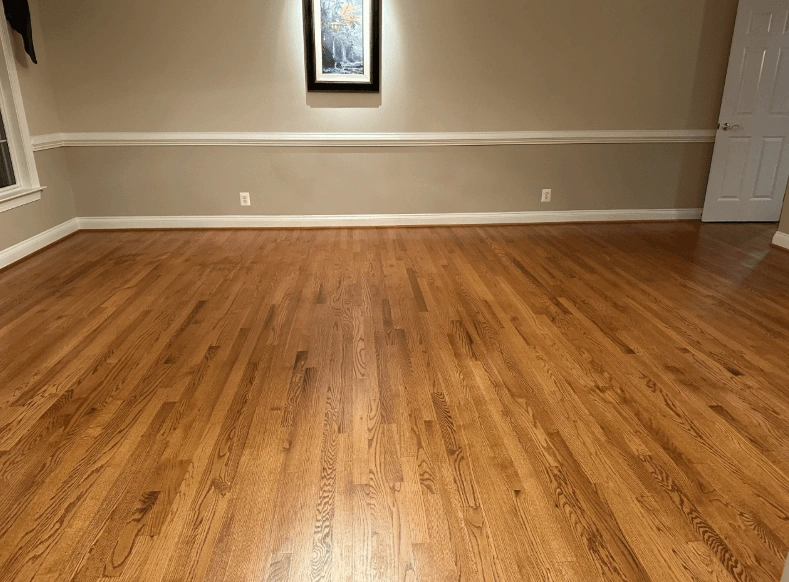 Refinished red oak floor running the length of a Broken Arrow living room